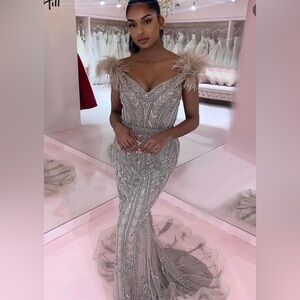 Gorgeous beaded dress with feather and small train